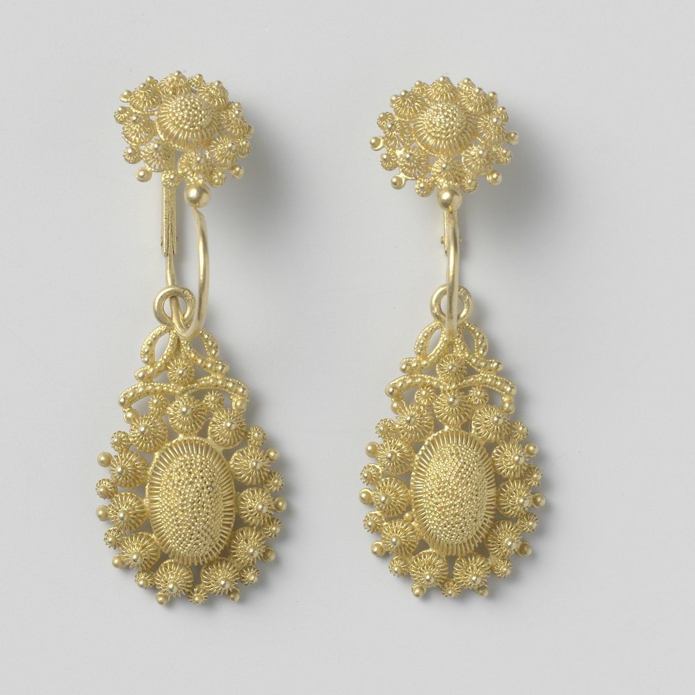 A pair of earrings laid side by side, both stones facing the camera.